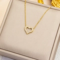 Elegant gold titanium heart necklace with white shell inlay and zircon accents on a jewelry box - Hollow Pavé Heart