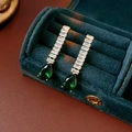 Detail of drop earrings with white crystals and green waterdrop stones on velvet - Green (925 Sterling Silver Pin)