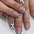 Detail of long square press-on nails with black and white cow print and rhinestone edges - Yellow Jelly Glue + Nail File Set