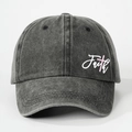 Close-up of Faith embroidery and pink cross on washed dark grey cotton baseball cap - One Size / Black