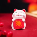 White Maneki Neko figurine holding a red lucky bag, festive cartoon desktop ornament - Blessing Arrived Cat