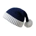 Close-up of navy blue knit Christmas hat with white pom-pom and thick ribbed texture - One Size / Navy + White Adult