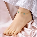 Gold anklet with sky blue gemstone and scallop shell charm on pink silk fabric - Scallop