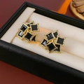 Macro shot of vintage gold-tone star earrings with black enamel in a jewelry box - Enamel Geometric (Silver Needle) / Gold Black