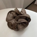 Close-up of a large brown satin silk scrunchie with layered ruffles and soft glossy finish - 16cm / Dark Camel