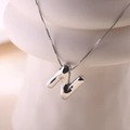 Macro detail of silver balloon style letter N pendant with high-shine polished finish - Letter N - Silver