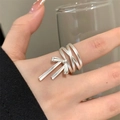 Detailed view of a silver multi-layered bow ring with polished metal finish on a finger - JZ0714-Wrap Bowknot