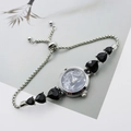 Close-up of silver quartz watch with heart gemstone and adjustable sliding buckle - Silver Black