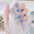 Close-up of glossy sky blue square oval press-on nails on elegant pearl lace background - Sky Blue (DFYL-06)
