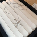 Detail of silver starfish pendant on a delicate snake chain displayed in a jewelry box - Silver Starfish Pendant Snake Chain Necklace