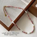 Pink and grey tiger eye beaded necklace with adjustable gold clasp on a jewelry tray - Rhodochrosite Shell Necklace XL0736