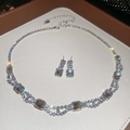 Close-up of sparkling square rhinestone necklace and earring set on white leather - Necklace + Earrings / Silver 2-Piece Set