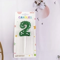 Green dinosaur style birthday candle number 2 with white polka dots in blister pack - Number 2