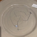 Macro shot of silver Saturn pendant with blue core and star charms on a link chain - Silver (Planet Star Moonstone)