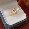 Macro shot of vintage gold-plated ring with white pearl and red gemstone detail - Gold (Real Gold Plated)