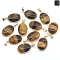 Set of ten oval tiger eye pendants with polished gold-plated metal edges and brown texture - Tiger's Eye