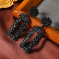 Close-up of black geometric earrings with hammered texture on a vintage silk background - Black Paint (WEH3966)
