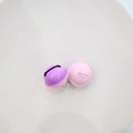 Detail of 2.2cm purple and pink metal bells with hanging rings on a beige tray - Pink Purple