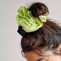 Oversized satin hair scrunchies in bright green and black colors shown on a hair bun - Black & Green
