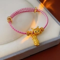 Close-up of pink woven bracelet with golden cat and peanut charms in a velvet box - 28# Bracelet - Pink Peanut