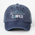 Detailed view of Happy Camper embroidery on a vintage navy blue washed baseball cap - One Size / Navy Blue