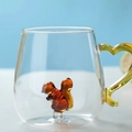 Creative glass mug with brown squirrel glass figure and yellow handle on blue background - Squirrel