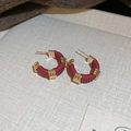 Detailed macro of burgundy leather wrapped around irregular gold geometric stud earrings - 41# Steel Earring Post-Wine Red Gold Wrapped Vintage Hoop Earrings