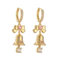 Close-up of golden Christmas bow earrings with pink heart zircon and bell charms - Gold Bowknot Bell