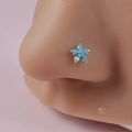 Macro shot of silver flower nose stud with five blue turquoise stones on a model - Blue Round Petal Flower