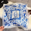 Elegant floral square silk scarf with blue equestrian patterns on plush background - Blue