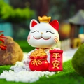 Lucky cat resin figurine in white and gold finish holding a peaceful scroll - Peace and Safety Cat