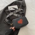 Black pebbled leather crossbody bag with red heart print and geometric strap - Black