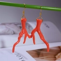 Close-up of orange coral branch earrings with gold metal hooks on an artistic background - Orange Coral Style (FN1016-1)