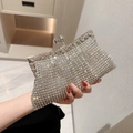 Sparkling silver rhinestone clutch bag with crystal closure held by a model for gala events - Silver