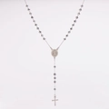Macro shot of silver rosary necklace with faceted beads, holy medal and cross pendant - Gray