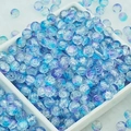 Macro shot of 6mm blue and purple gradient glass beads with unique ice crackle texture - 6mm / Blue Purple