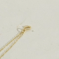 Elegant gold letter pendant necklace with fine chain and U-shaped clasp on cream base - Letter U(UXL2998)