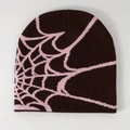 Detail view of the dark brown knitted beanie featuring a pink spider web jacquard pattern - Coffee