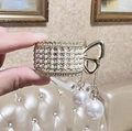 Detail of golden hair claw with pearls and rhinestones, featuring a bow and pearl pendants - Tassel Gold Rhinestone & Pearl