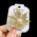 Elegant maple leaf brooch with sparkling crystals and a large white pearl in gold finish - Golden Maple Leaf Pearl