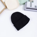 Detailed view of black knitted beanie with soft texture on a minimalist lifestyle background - M (56-58cm) / Black