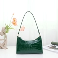 Dark green baguette bag with crocodile texture and golden zipper detail - Green