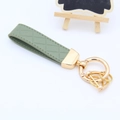 Elegant green braided leather car keychain with luxury gold metal hardware accessories - Green