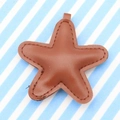 Brown faux leather star-shaped keychain accessory with fine stitching and metal loop - Brown