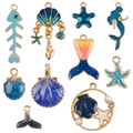 Set di 10 ciondoli in lega blu a tema oceano con stelle marine, conchiglie e sirene - Serie Blu (10 pezzi)