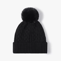 Black cable knit beanie featuring a large faux fur pom-pom and thick ribbed cuff - One Size / Black