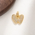 Detailed close-up of a golden butterfly pendant with micro-paved sparkling crystals - Letter W