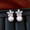 Close-up of 18K gold-plated floral pearl earrings with shimmering cubic zirconia accents - Silver Flower Pearl Earrings