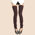 Detailed knit texture of thick chocolate brown over-knee leg warmers on a model - One Size / Coffee