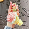 Handmade crochet floral bouquet keychain in pink and white with a golden bell charm - Pink